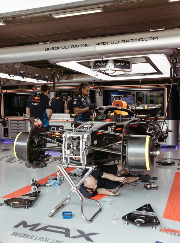Technicians working on an F1 car in the Red Bull Racing garage.